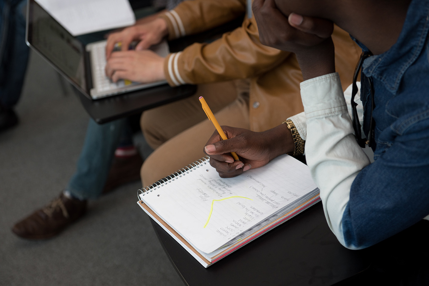 Student writing in a notebook
