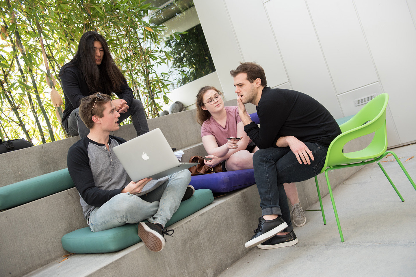 Four students sitting in a common area at Emerson Los Angeles chatting