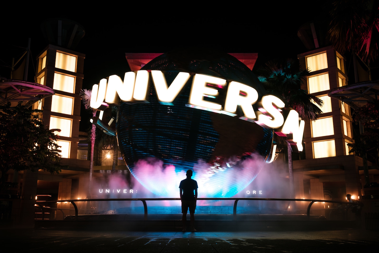 Person standing in front of Universal Studios fountain