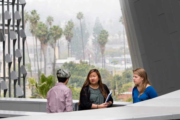 Emerson Los Angeles building outside with students standing against the cityscape