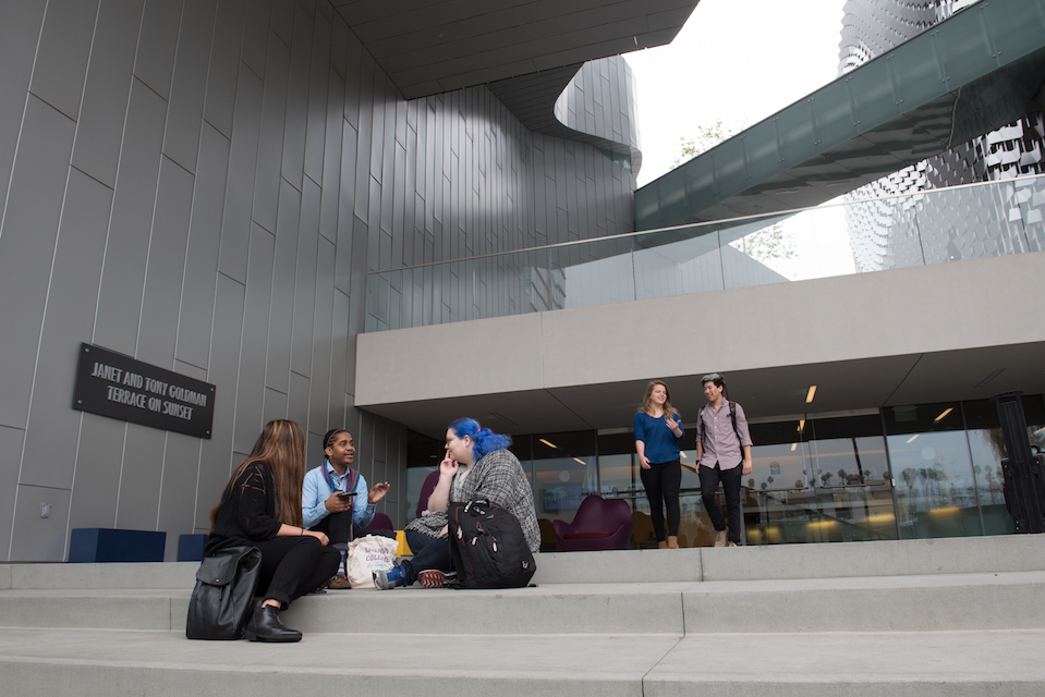 several students sitting on steps outside Emerson Los Angeles facility